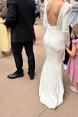 Where do I even start with this story? Long story short, the dress that someone offered to make me didn't turn out how I had hoped a few days before our wedding, and this dress became the hero of the story- I had it as an optional reception dress. I was so comfortable- no mobility issues and the dress wasn't falling off. I felt timeless. Since it was a last minute change, we didn't have time to take it to a seamstress so, my mom fixed the shoulders- originally with just safety pins and then she was able to sew it. We took the bustle from the other dress and made our own. I would recommend clothing tape for the front and back so that you're not self conscious. If you can put in a bustle, it would be a great idea since the train is beautiful and you'll want to dance in this guy. Material wasn't too heavy and I had the time of my life on the dance floor in this. Thank you so so much, Lulu's!! I am so grateful. I can't begin to express how much I appreciate this lifesaver dress. I only have photos of it bustled! - Lela K.