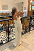 I loved this dress. I was somewhere between a small and a medium. I opted for the small because the fit was more flattering, being tighter than baggy. I had to have the length brought up. The bow in the back was my favorite part. I highly recommend this dress to all future brides. - Nicole G.