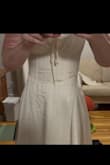 The dress is very cute and fits pretty well. The only issue is that the skirt was cut and sewn on crooked, so not only does it not line up in the center cut, but you can see how one side is higher, and the rounding at the waist is more in the front than on the side. While I don't think it's noticeable in motion, you can feel it while wearing it. - Gabrielle C.