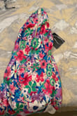 Hate it! I ordered the teal and pink floral dress for a wedding. They want the guests to wear light pastel colors, so the colors on the model on Lulus' website were perfect. Until the dress came, smh. The dress is giving Hawaiian luau, and the neckline is not the same as the photo. Now I'm stuck with this dress because I can't return it, smh. Donation bin! - Tamekia A.