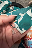 Love this but unfortunately I can't wear it due to the loop and button closure in the back. The loop is so small you can't get it around the button, my husband and I both tried. And when I was inspecting it to see how I can make it wearable the button was not even sewn on completely and fell off in my hand. Really disappointed in the quality and functionality of this outfit for what I paid for it - Randi K.