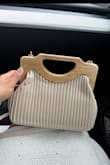 I absolutely love this purse! The color is beautiful and goes with so many outfits, but what really sold me was how cute and unique the overall design is. The wooden handle gives it such a different look and makes it stand out. It's even cuter in person! - Carol R.