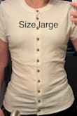 The shirt runs extremely small, especially compared to how it fits in the model photos. I order from Lulus all the time and I normally wear a size small, so that's what I ordered. You can see in the first photo that the shirt fits super skin tight, puckers all over, and highlights every bump and curve on my stomach. I wanted it to drape down in a slightly loose way like in the model photo, so I exchanged it for a size large hoping that would do the trick. As you can see in the second photo, the large is still very fitted and still doesn't drape at all like the model photo. It's really meant to be a tight shirt even if you go up two sizes. I'm going to keep the large because it's kind of cute when I wear it as an open jacket completely unbuttoned, but I'm really disappointed in the fit overall, and I don't think it fits as advertised. - Angelica S.