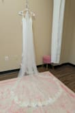 It fit perfectly, true to size, no alterations needed, adjustable straps, flattering. 10/10! I ended up getting the length cut just a tad and added a bustle. Very comfortable and flattering. - Lauren D.