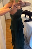 Very flattering! Might just be me, but it's looser towards the bottom and tighter up top. True to size mostly. A bit long. I'm 5'7 and need to wear 2.5-3 inch heels to achieve floor length where it isn't fully dragging along the floor. Otherwise, I would need to have it shortened. - Emily O.