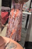 Fits perfectly! Hides my apron belly and is very flattering all around. Won't need to wear a bra with it, as it has adjustable straps to hold them up! Absolutely obsessed with it. Will look gorgeous in my friend's Mexico wedding! - Cheyanne E.