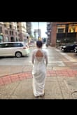 I wore this dress for elopement photos at a courthouse. It fits true to size. I did want mine on the tighter side, so I got an XS, but I could have gone with the S, as the lace sleeves are pretty snug! I didn't experience it being see-through at all. Not a ton of bust support for larger chests, but still comfortable. I used a steamer to smooth the wrinkles, and it looked beautiful! I loved this dress so much. It's the perfect blend between classy and sexy! Lots of compliments, and it felt high quality. I can confidently recommend this gorgeous dress! - Chelsea G.
