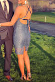 I love this dress! I bought it for as a wedding guest dress/party dress and it was perfect. Received so many compliments. The blue is beautiful. I will say that it runs slightly snug, it's not very stretchy so while it did fit me like a glove I could not have afforded to gain anything extra prior to wearing it. The lace up back works great if you are someone with a larger back size/ broader shoulders (like me) but with a smaller waist. The ribbon allows you to size it accordingly, including how high up on your neck you want it. I wore a sticky cutlet bra and it worked out well. I noticed the lace ripped a little by the zipper by the end of the night from me pulling it on and off, but I'm guessing that's more my fault than the dress. I felt it was made very well and the lace fabric was good quality. The lining also makes it more comfortable although the slit in the back goes up a little higher than I expected. Still perfectly appropriate in my opinion - it's a classy look. - Sarah D.
