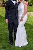 I bought this dress for prom, after an incident with another company didn't work out, and I am beyond satisfied with the dress! I just wish they had Small in stock because my sizes (Bust: 33, Waist: 28; Hip: 35) are more suited with a small. However, when the dress came, I was very happy with the purchase-- while the dress was a little loose here and there, it was a comfortable fit, and the space came in handy when I was sitting, moving around, dancing, etc. The only thing is that the dress was very tall/long-- I am 5'6" but I wore 3 inch heels and even so, the dress was just touching the ground; of course, this can be tailored so it is not too big of a problem. 
Another reason I got this dress is because I think it'll be great to use in the future (college formals, galas, etc.) It's classy and keeps it simple. I like rather minimalist aesthetics, so this dress was great for me. 
For the pictures, the color is more true to the first picture (the one with the girl). It's a nice cream/milk white color. The other picture was edited a bit so it appears more white. The dress is also adaptable in this sense-- under warm light it appears the cream color; under more fluorescent light, the dress can appear more white, but both look amazing!! I got many many compliments :) I'd highly recommend this dress - Qihong X.