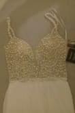 It's simple and flows nicely. The beaded top looks just like the pictures, and the built in bra fits perfect for a 34b. I love it! - MARIA C.