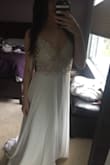 I bought this dress for my upcoming bridal shower. This dress is even more beautiful in person. The detailing on the top is exquisite, doesn't look cheap at all with the different bead/stones, it's gorgeous. I was nervous about the padding in the cups being to visible but you can't tell when you're wearing the dress. The bottom was a lot more fabric than I thought it was going to be but it's still very flowy. It's really long, I'l have to get it altered about 4 inches off but all in all I love this dress and I can't wait to wear it! - Natalie B.