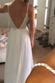 Thank you, Lulus!! All the other reviews were right when they said that pictures really don't do this dress justice! It is stunning on and looks so much more expensive than $250. I was a little nervous about the rhinestones looking chancy but the beading is actually beautifully done in scallops that will look perfect for our beach vows. The straps are a perfect length and the built in bra fits really well - I wouldn't want to change a thing! There's a little extra room around my rib cage but the actually waist of the dress (where the zipper stops in the back) fits great so I know it's the perfect size! I think the looseness of the rib cage area is mostly due to the style of dress/open back vs actually being "too big". The only alterations needed will be to take a few inches of length off since I want to be in sandals or barefoot. If I were going to wear a small heal/wedge shoe, no alterations would be needed. - Madeline B.