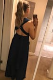 The material of the dress is stretchy and super comfortable. I tried it on a few ways and it's cute in all the ways I tried. I plan on wearing it for a bridesmaid dress this summer. I can never tell if I'll be a small or a medium in things... I ordered in a small and it was great. - Lucianna W.