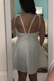 Beautiful!! The material is really thick so it isn't see through at all in white. I am usually a medium in other stores but the larges at Lulus have been fitting me better. This fits perfectly. The slip underneath is a bodycon fit so you feel more comfortable with the very wide flowy skirt. The deep v neckline is deep enough that you'll need a U-plunge backless bra, that's what I plan to get for this dress. The outer straps in the back go out pretty wide so I may have a seamstress move them in towards the middle of my back. I don't have a wide back so that might be better on someone else. I can't wait to wear this for my bachelorette party in August! - Rachel M.