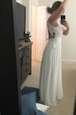 Usually a size 8, ordered a M and couldn't zip up the back all the way. Loved the back! And the side. Front made my shoulders look broad but they are a little broad anyways. It's cute! Nice and long that's for sure. I also liked the slit. - Jordan B.