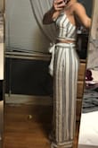PLEASE for your fun-sized peeps make things in petite sizes too! But I ordered this and it took me a minute to decide whether I liked it or not. I love it! I brought it today to get tailored (the straps for the top are super long and stretchy so they need to be shortened, and the pants need to be shortened as well - I was thinking of having her do it from the top of the horizontal stripes so I kept the entire chunk but she folded the bottom part in half to show me the hem and honestly I think it flattered my height and still elongated me better, so that's what I'm doing! The pictures are pre-tailoring.
I feel as though it fit well, but the top is reallyyyyy snug so if you have a bigger chest or don't like things being too snug then I'd go a size up. As for the pants, they fit really really well. I couldn't decide if the bagginess made me look bigger or looked right for the type of pant and I decided it's the way it should look. I personally like the tie in the back better, but that's just me. The only other thing that stinks about this order is you can't order two different sizes (like a smaller/bigger top and pant) which is unfortunate. I'll be the first to say it doesn't look super flattering from the front in the picture but once the pant leg was at the appropriate length it fell a LOT nicer. - Amber P.