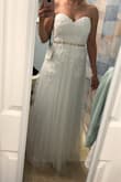I ordered this dress and another to try on as a wedding dress. My Fiance said "WOW" and I said Yes to this dress! This dress looks like it came straight from a high end bridal shop. The material in the top feels light, soft and comfortable on the inside. The barely there boning that supports the deep sweetheart, gives the waistline a good shape and keeps the dress in place. The bottom layer of tulle does tend to ride up a little with a lot of movement (I tried dancing around to see how it moves) and the back of the tulle by the zipper sticks out a little due to the fact its not attached to the seam there to prevent rips in the material. Other than those minor things this dress is Perfect! So happy to finally find a dress I LOVE for my special day. - Christa M.