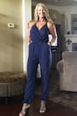 I was hesitant to order at first considering I am long waisted and just not an easy fit in pants due to fuller thighs and bottom! But after reading reviews and seeing photos of how flattering this jumpsuit was on, I couldn't resist! I ordered navy and gray! I normally wear a small in Lulu maxi wrap dresses, but I sized up to a medium.. Perfect, perfect! The material is nice and the jumpsuit is very versatile. The side pockets are wonderful and do not pucker. I am including two photos, one with my hands in pockets. - Brenda F.