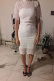 I'm 5'2, very small on top with wide hips. I'm usually a 26/27 in jeans and an xs in tops. I purchased an XS. This dress was so beautiful and well made. However, the chest area fit loose and the bottom fit tightly on my hips. It has almost no stretch, which enhances the quality and look of the lace, but because of the tightness in my hips, it kept riding up making the top even baggier. Such a shame, because it's soooo nice otherwise! 4 stars only because it didn't fit me. Returned. - Jannine M.