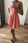 I had been eyeing this dress for a while, and after reading the reviews I ordered a size XS.

The fabric is polyester, so it's nice and stretchy. The skirt has a nice skater swirl.

Colour is exactly peachy.

Recommended! - DaniÃ«lle T.