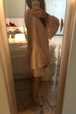 This dress is super cute! I ordered a XS which is what I usually order from lulus, however, I didn't take into account how long it would be on me since I am shorter and it does appear to run a little past the model's finger tips. The sleeves fit great but the actual body of the dress does run a little big, but I'm sure that is how it is suppose to be. - Abigail G.