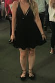 The medium fit me almost perfectly. I wore it to NYC to see a Broadway show. I used an adhesive bra because that's really the only option. Definitely shows a lot of cleavage, but the length of the dress makes it less revealing overall. The straps in the back are cute, but I only have pics of the front of the dress. - Brigitte F.