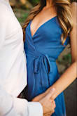 I love this dress so much - wore it for my engagement pictures. It flows nicely and feels like a nice thick material - not see through at all. If you have a larger bust, I would definitely order a size up. 

I wore petals and used double sided sticky tape. I recommend Fashion Tape - I usually use this, but I bought a cheap kind from target when I wore this dress and it didn't stick well to the underside. - Sarah B.