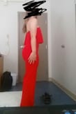 This jumpsuit is excellent - I was a bit concerned about the length of the torso but it fits flawlessly on the top half. I am bottom-heavy, and have thicker thighs/bum than my upper body/breasts so I always end up having to order a size that will fit my behind first. Often times this sacrifices the fit of the top if I order a dress or romper, but not in this case! The top half of the romper is flattering and stays up on my body easily. Great for dancing since it has rubber lining to keep the top in place. The ruffle detail is adorable, the color is as vivid as the photograph shows, and the deep v-neck maintains its shape with wiring, which doesnt sacrifice the comfort of the jumpsuit!!

Downsides? If you are similar to me, with a bigger behind and a smaller upper body, you may have to get this hemmed depending on your height. The medium is at least a foot too long in length for my legs, but the small would have been too tight/uncomfortable. In these photos I am standing in my tippy toes and it is still too long. For this reason, I gave the jumpsuit 4 stars. - Kathleen B.