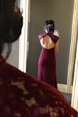 Such a lovely dress and is a nice thick material so it wraps around curves pretty well and is quite forgiving over lumps.The bottom of the skirt does flare out just a bit and if you were to hem the dress, you may lose the flow.  I wore a 4 inch heel (and just kicked the dress as I walked).
The dress seems a bit two toned, with the lace top being a true burgundy and the skirt a shade more on the red tone.
The back also was not as low as I would've liked (was hoping it would fall right into my waist for a more hourglass look), but it was not a big deal. X-small was the perfect dress size for me. - Ivy S.