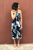 It fits loose on the bust area. Got a small, had to wear a strapless bra in order for the romper to stay in place. Other than that it's a beautiful romper!! Received a lot of compliments! - Nemesis M.