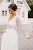 Absolutely stunning. We had an elopement ceremony and I originally set out with low hopes of finding something I fell in love it on short notice. Ordered this dress and as soon I put it on I knew my hopes had been far exceeded. The back of the dress is so flattering, paired with the sleeves it makes a timeless and classy with an edge. I had so many compliments, and even was featured on the wedding venues page because of the back of the dress. Would highly recommend! Had bottom altered for length because I am short, but am totally satisfied otherwise. - Kati C.