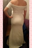 The dress fits better than I expected, but it is a bit too tight around the hips for my liking. The sleeves aren't abnormally tight, but they do restrict arm movement somewhat. Like the other dresses I've ordered from Lulus, this one needs hemming. Color is certainly not white, more like ivory/light cream, which is preferable in this case - bright white would look too cold with my skin tone. I will be hiding the waist seam with a belt, since it is a bit too noticeable. Overall I would recommend this dress, just be aware of the tighter fit compared to some other Lulus dresses. For the price I do think the quality is pretty good - the fabric feels heavier than I thought but it seems to wrinkle easily, and any imperfections show a lot more clearly through this fabric than for example lace. The top part is very pretty, and the V is well constructed. Will definitely be wearing this after making some small adjustments! - Katja T.