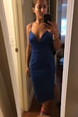 I love this dress. Originally ordered in M because they were out of S (first picture is S, second was the M I will return). The small fit perfectly, with still plenty of stretch. It's very flattering, especially the top neck line which I think is a beauuuutiful cut. I love that the straps are adjustable. I also like the length, I think it's sexy but not "extra" haha and I know I'll be comfortable dancing in it all night at the wedding I bought it for. The blue pops it's so bright where it catches the light! The material is soft and stretchy it's amazing. Buy this dress. - Amara L.