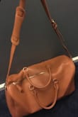 Love it! It looks just how it does in the photos, the strap is super cute and it fits a good amount in it. It's the perfect travel bag! - Jerica Y.