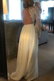 I will be wearing this for my bridal shower next weekend. I love the way it looks on, although if you are more broad in the rib cage area it may be a little tight considering what size you order. I wear in between smalls and mediums usually, and I ordered this in a small. It was a little bit of a challenge to hook in the back, but once I got it I felt secure. I do have to get it hemmed because it is fairly long. But besides that, I love it!! - Elizabeth R.