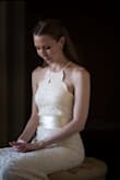 I used this dress as my wedding dress and could not have been happier. The lace is amazing quality, with an opalescent stitch to highlight the lace accents. The dress is very long if you are short like me. I ordered the Small which fit my hips perfectly but I needed to take in the top about two inches but it was an easy alteration my mom was able to do for me. I wore 6 inch heels instead of hemming to preserve the beautiful trumpet base. - Heather J.