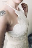I really like this! I just bought it on a whim because it was on sale and now it's serious contender as my wedding dress! I got a medium and it fits well, I am getting it tailored a bit as it's too long and I might get the adjustable straps replaced. I'm a little smaller on top so I had to tighten the straps almost all the way to get it to lay flat against my chest. The ribbon detail at the waist is a little tight and hits me in an awkward spot above my natural waistline, kind of around the bottom of my rib cage. It's a little tight around the hips on me but I love it because my booty looks amazing! I will be wearing light shape wear with it just to make myself feel more contained and smooth though! - Katrina M.