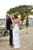 I wore this dress for my backyard wedding and I loved it!! It hugged my curves (in the right places), fits tight but stretches and the detail is amazing. However, I gave it three stars because by the time I reached my reception the dress was falling off! The bottom was heavy and it pulled down on the stretchy top. That being said, I recommend having another dress to change into! Luckily my sister came through and had a backup white dress in her car for me to dance in. It was perfect length with flats. - Shea H.