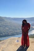 I bought this dress for my engagement shoot because I was looking for a flowy dress. Pros: -very flowy and soft (I could've been in it all day!) -color really popped in the pics -fit like a glove -loved the lightweight material -exactly what I was expecting. 

Cons: -The dress has no stretch so be mindful of that. I ordered a M, which is my usual dress size, and it fit perfectly. - I have a very short torso so the look in the back wasn't the same, which was a little disappointing but that is a personal thing. If you have a long torso you will be fine! - One thing I wasn't too excited about was the underlining. In my pics, you can see the difference between the full length and the underlining (again another personal thing not a deal breaker!). 

Overall I am happy with the dress! Versatile in that you can dress it up or dress it down! I'd say its a winner! - Anusha S.