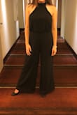 So I bought this jumpsuit for a wedding and fell in love with how it made me look and feel. I'm not very tall, so the high waist and long wide leg made me feel tall. However, I had to get this jumpsuit tailored in the waist because it was way too loose and then I had to get the legs shortened, even with my highest heels. Instead of shortening the legs at the bottom of the pants, my tailor cut the waist in the front and lifted the pant section up to shorten the legs and so that the intimate area doesn't hang super low (because as other reviewers said it really does). Now, the jumpsuit fits perfectly and I love it.... but I paid MORE for alterations than I did for the actual jumpsuit. - Lucy K.