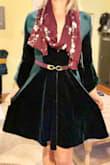 Once I took it out of the box I could tell it was good quality.  Nice thick fabric that will keep you warm. Soft and cozy. The dress is given a sexy look by having a very low cut v neck. I might get it tailored because of some extra room in the bust but I wouldn't size down.  
I have an athletic built with broad shoulders - this dress was still super comfortable with room. So if you are more petite, I suggest sizing down.
Was planning on wearing this to a work party but I might feel a little uncomfortable with the low V cut unless I pair with a scarf. - Paige F.