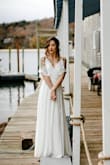 I bought this dress for my elopement, and it was the perfect choice! I'm normally an XS, but probably could've sized up to a S for this one. I had to do some wiggling to get the zipper up but when it got there it fit like a glove. I could've had it hemmed (and probably will so I can wear flats with it) but with a good pair of heels at 5'4" it just dusted the floor and looks beautiful! - Lauren P.