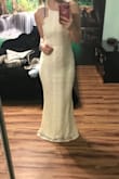 I bought this dress in size small. When I received it, I knew it would need to be hemmed before my wedding. We took about 4 inches off, otherwise it fit perfectly everywhere else. It was such great quality and I got so many compliments. Also, this dress has two skirts under the lace. My wedding was in November on 40 degree weather day. I was okay taking outdoor photos in this dress. Overall it is beautiful and for such a great price! Also, the photos I am sharing are right after the hemming and with no heals. - Ariel S.
