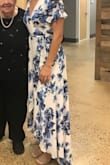 Wore this dress for my bridal shower and loved it! I typically wear a size small but was able to get away with ordering a size down since it was a wrap dress. Plenty of room in the arms and was not constricting at all. Good length with short heels. Got LOTS of compliments and overall am very happy with this purchase! - Danyelle F.
