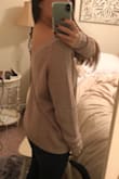 The material of this sweater is good quality, and it is very comfortable. I love the back of it too! Perfect for a chilly night out! The medium was perfect, a little loose, but it that is how I wanted it to fit. - Hilary S.