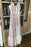 As soon as I pulled this dress out of the shipping dress, I was in awe. It's so girly and dainty. I was immediately in love with it. I ordered a medium, however, which was way too small for my measurements. If I wanted to keep the dress, I would've exchanged for a large.
I returned this item because it just didn't feel like a wedding dress. I think I would've considered it if it were pure white or even ivory, but this dress comes off as pink to me. Still, it's a pretty dress for a bridesmaid or some other occasion. Make sure to wear a slip under it thought; it's pretty see-through. - Julianna R.