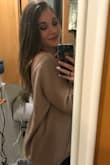 I wear this sweater all the time and everyone asks me where I got it. The back is low and looks super cute, it falls just onto my shoulder (pic included), and it's a baggy fit which I love. The color matches just about everything I own as it's super neutral. I would highly recommend!!! - Jessica P.