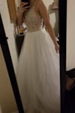 When I tried the dress on it fit perfectly! I felt like a princess and I instantly knew this would be one of my two wedding dresses. The beading details are just beautiful and it adds a lot of weight to the dress. The layers of tulle are just perfect - not too fluffy but just fluffy enough to feel like a princess in this gown. The only things I didn't like but are an easy fix are the built in bra or cups. I think I will just sew on extra white fabric to the whole top (I'll have to see how that looks). Also the straps could've been a better material, but if I really want to it could be an easy fix as well. Love, love, love this dress. - Leyna N.