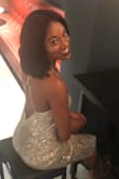 I think in the photos on the site it looks more silver but it has a gold tone to it in person. It fit perfectly and had adjustable straps in the back to make it a little tighter or looser as you please. I wore this for NYE! Got lots of compliments on it ! - Courtney H.