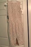 When I first saw this dress online, I was immediately drawn to it. I loved the lace and the slit in the back. In the picture it looks very white with only a little nude slip underneath, but in person the dress is WAY more nude than I initially imagined, which threw me off. The only reason why I rated this dress as a little small was because it was hard/tight to get on, but once it was on it was very comfortable and easy to sit and didn't feel tight at all. I am bigger chested and with a bra on, it still fit nice in the bust. Getting the dress off was almost a two person job though, and personally the length was not flattering on me. Overall, the dress is still very elegant and mostest, great for a rehearsal dinner or formal event, and very great quality material and lace. - Kaylee R.